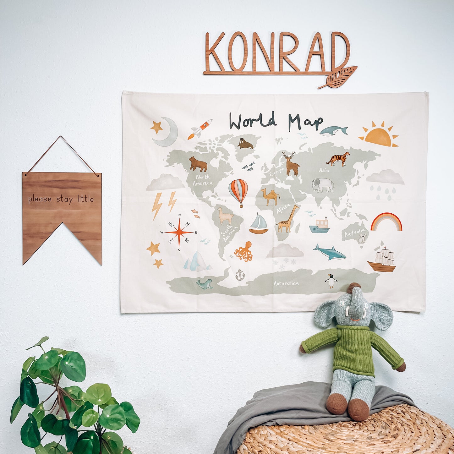 Load image into Gallery viewer, cut out name sign with leaf accent over an animal world map, next to a please stay little sign, and a green plant.
