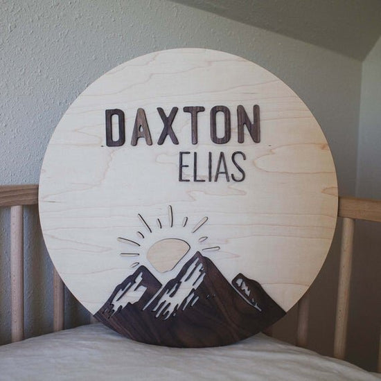 Custom mountain name sign in a wooden crib.