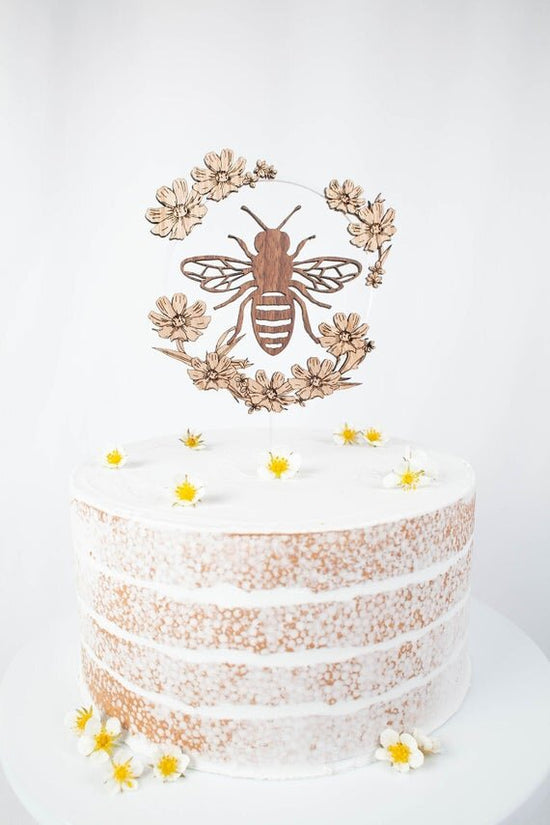 Bee Cake Topper with Flowers, birthday bee cake topper on a white cake.