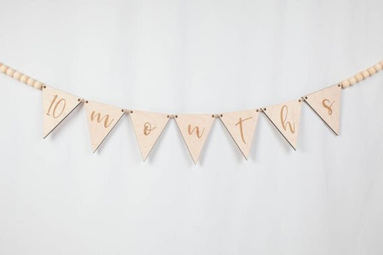 Load image into Gallery viewer, Custom banner, pennant flags with wooden beads on a white wall.
