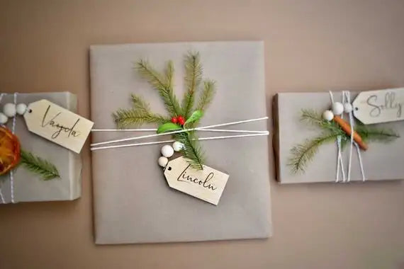 Load image into Gallery viewer, 3.5&amp;quot; personalized wooden tags with wooden beads on 3 gray wrapped Christmas gifts
