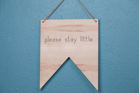 please stay little nursery quote sign with blue wall