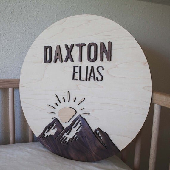 Custom mountain name sign in a wooden crib.