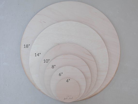 Load image into Gallery viewer, All available botanical engraved wooden baby sign sizes next to one another.
