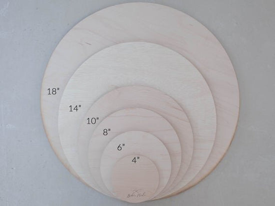 Load image into Gallery viewer, All available botanical engraved wooden baby sign sizes next to one another.

