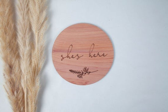 She's here red cedar wood birth announcement circle with botanical decor