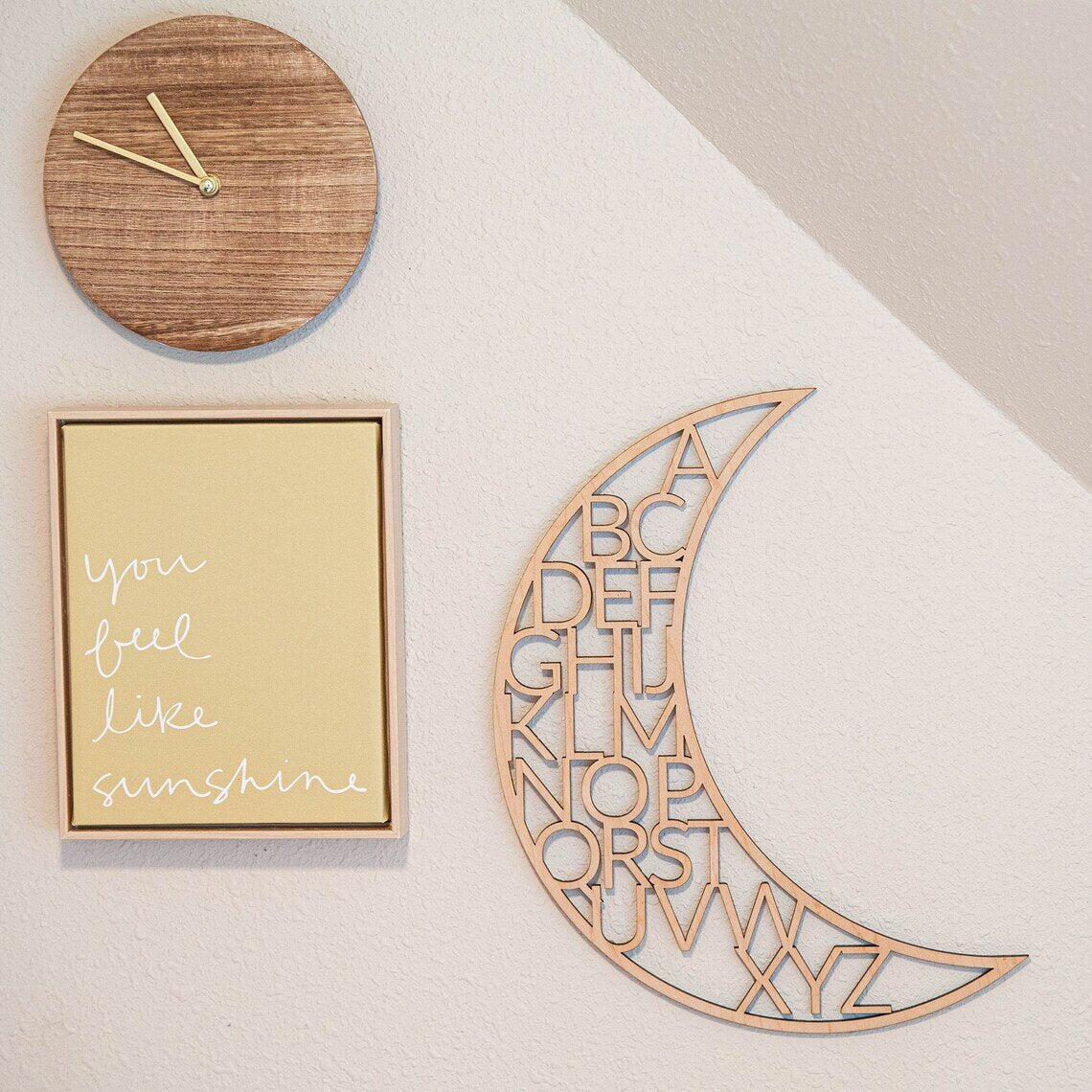 wooden alphabet moon nursery decor next to wooden clock, and you fee like sunshine canvas